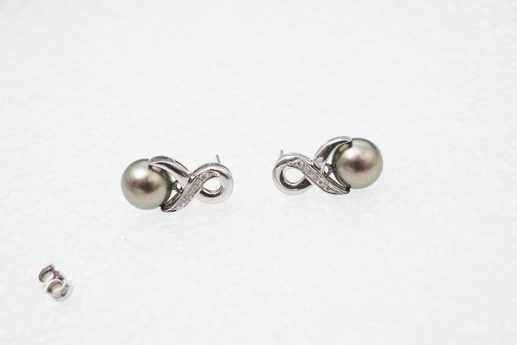 A pair of cultured pearl and diamond earrings